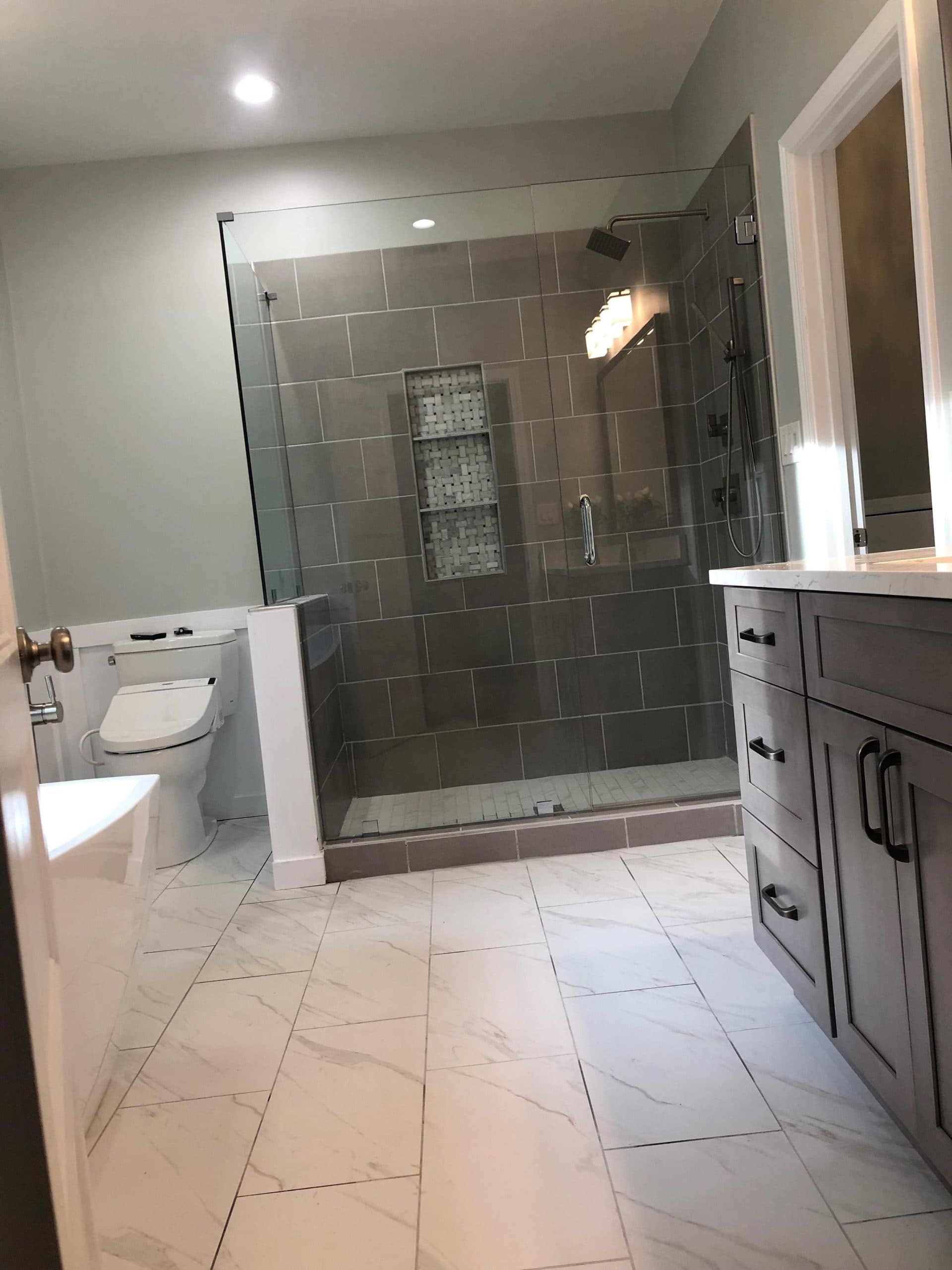 Renovated bathroom with tiled shower surround