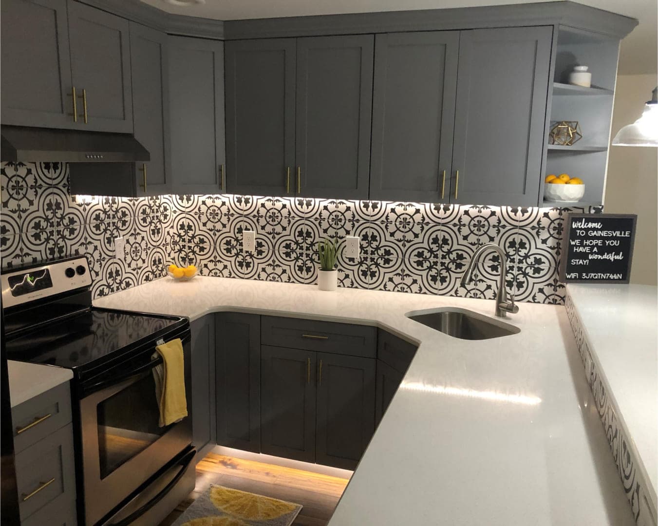 Kitchen remodel with patterned tile backsplash and quartz counters